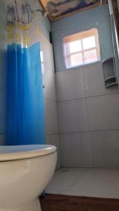 a bathroom with a toilet and a window at Piratas Cabanas Camping Bar in Parati-Mirim +29 photos