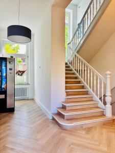 a staircase in a home with wooden floors at Pension Am Sültebrunnen in Bad Oeynhausen
