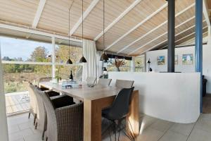 a dining room with a wooden table and chairs at TV1597-Albaek-Albaekvej-78 in Ålbæk