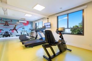 a gym with two tread machines in a room at Nacional Inn Palmas in Palmas