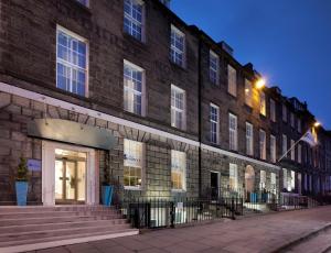 a building on a street with a street light at Hotel Indigo Edinburgh by IHG in Edinburgh