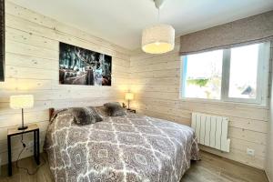 a bedroom with wooden walls and a bed with pillows at Le Balcon des Princesses in Demi-Quartier +7 photos