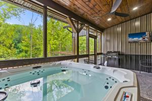 a large bath tub in a room with a large window at Sleeps 24/ 4 Kitchens / 4 Hot Tubs / 4 Firepits in Slade +123 photos