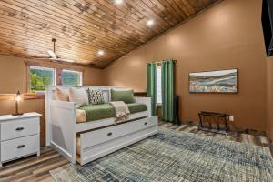a childs bedroom with a white bed and a wooden ceiling at Sleeps 24/ 4 Kitchens / 4 Hot Tubs / 4 Firepits in Slade