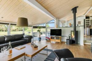 a living room with a couch and a table at TV1598-Jerup-Kippen-32 in Jerup