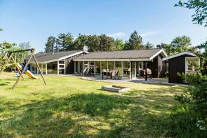 a house with a playground in the yard at TV1598-Jerup-Kippen-32 in Jerup