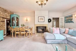a living room with a couch and a table at Above Rubies - Cross Cottage, Luxury, Dog Friendly in Haworth