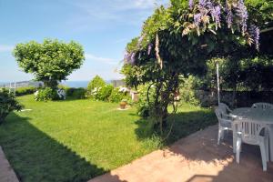 a patio with a table and chairs in a yard at Casa Sayanes in Vigo