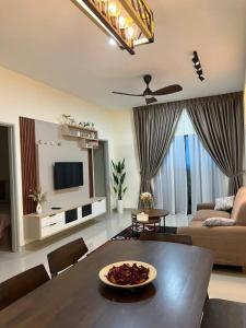 a living room with a table and a couch at Highland Chill Retreat in Tanah Rata
