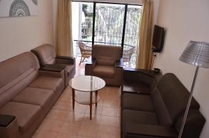 a living room with a couch and a table at ARYASREE homestay in Kodaikānāl