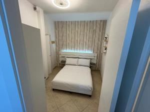 a small room with a bed and a window at Vittoria Mini Apartment in Campobasso