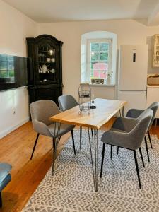 a dining room with a table and chairs at Historic Railway Cottage At Mount Arber in Bayerisch Eisenstein