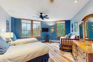 a bedroom with two beds and a ceiling fan at Palmyra 4A - Panoramic Peaks Lodge in Telluride