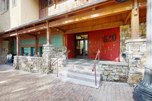 a building with a red door and stairs in front at Palmyra 4A - Panoramic Peaks Lodge in Telluride