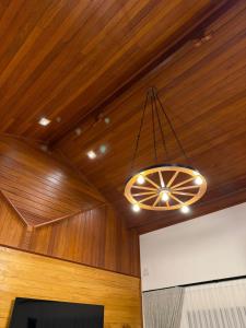 a chandelier hanging from a wooden ceiling in a room at Pequena Suíça Hotel Boutique in Chácara