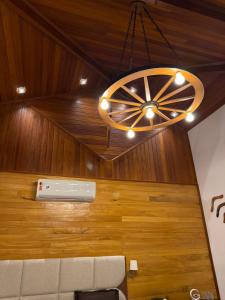 a chandelier hanging in a room with wood at Pequena Suíça Hotel Boutique in Chácara +44 photos