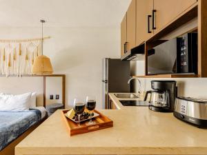 a kitchen with two glasses of wine on a counter at Tulum City Apartments Bakal C in Tulum