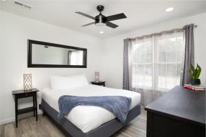 a bedroom with a bed and a ceiling fan at Cozy Corner Spacious Area Outdoor Lounges in Knoxville