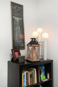 a book shelf with a lantern on top of it at Cozy Corner Spacious Area Outdoor Lounges in Knoxville