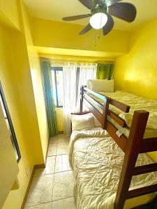 a bedroom with two bunk beds and a ceiling fan at Condo 2Bedroom near Session with Free Own Parking in Baguio