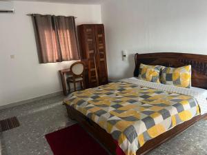 a bedroom with a bed and a chair in it at Jade in Assinie +18 photos