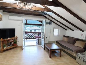 a living room with a couch and a table at Green Valley GV in Kotor