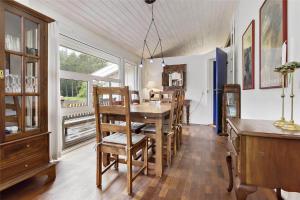 a dining room with a wooden table and chairs at TV1285-Bindslev-Tannisgardvej-16 in Bindslev