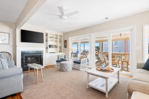 a living room with a couch and a fireplace at 1709 E Ashley Bacon in the sun in Folly Beach