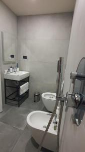 a white bathroom with a toilet and a sink at RADIO HOTEL Lushnje in Lushnjë +36 photos