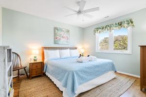 a bedroom with a bed with two towels on it at 1709 E Ashley Bacon in the sun in Folly Beach