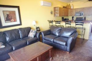 a living room with a leather couch and a table at Casa Arco Iris in La Choya +12 photos