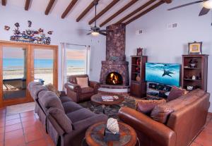 a living room with a couch and a fireplace at Playa Vida in Puerto Peñasco