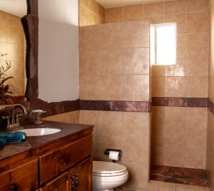 a bathroom with a toilet and a sink at Playa Vida in Puerto Peñasco +9 photos