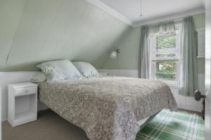 a bedroom with a bed and a window at Charming Centrally Located Seaside Retreat in Old Orchard Beach