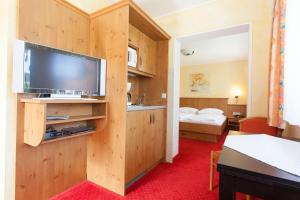 a hotel room with a large flat screen tv at Appartments Reiter am See in Inzell
