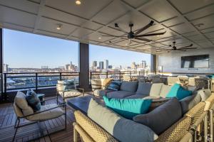 a living room with couches and chairs and a large window at Luxury 2BR Steps from Railroad Park in Birmingham