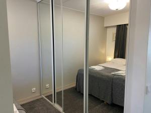 a small room with a bed and a glass closet at Modern Apartment for 2 with Sauna in Kemi