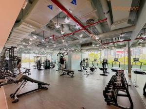 a gym with a lot of treadmills and machines at Magnificent living at Downtown in Dubai