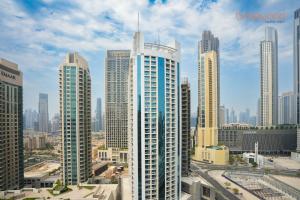 a group of tall buildings in a city at Magnificent living at Downtown in Dubai