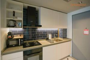 a kitchen with a stove and a microwave at Magnificent living at Downtown in Dubai +15 photos