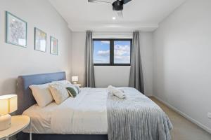 En eller flere senge i et værelse på Stylish Apt with Balcony Easy Access to Everywhere