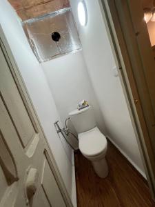 a small bathroom with a toilet and a door at Dar Latifa in Fès +8 photos