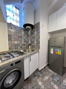 a kitchen with a washing machine and a sink at Dar Latifa in Fès