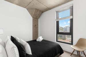 バーミングハムにあるModern 3BR Condo Five Points South Gemの黒と白のベッドと窓のある寝室 +50枚の写真