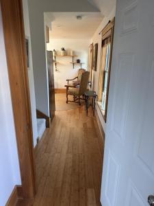 a hallway leading to a living room with wood floors at The Woodland Loft at Falmouth in Pleasant Hill +2 photos