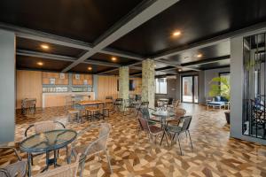 une pièce avec des tables et des chaises et une cuisine dans l'établissement YASA Residence Fatmawati, à Jakarta