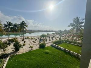 a view of a beach with palm trees and a body of water at Stylish 2BR in Hawana Salalah with Beautiful Balcony in Wādī Khasbar