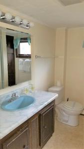 a bathroom with a sink and a toilet at Little Miss Cottages - 5 Seaview House in Old Orchard Beach +8 photos