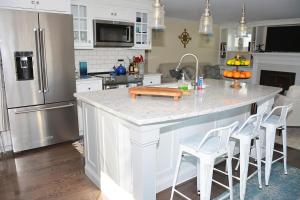 a kitchen with a large island with a counter top at Little Miss Cottages - 68 East Grand Luxury Condo in Old Orchard Beach