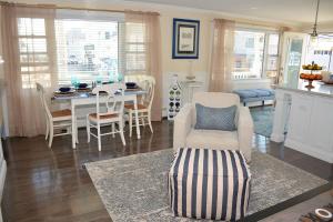 a kitchen and dining room with a table and chairs at Little Miss Cottages - 68 East Grand Luxury Condo in Old Orchard Beach